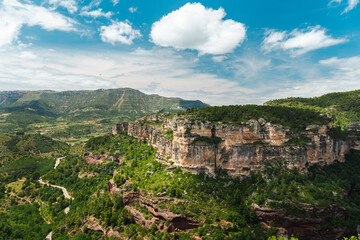 Obraz premium Siurana sandstone cliffs and winding mountain road in Prades Mountains, Catalonia, Spain