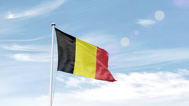 Belgium national flag waving in sky.