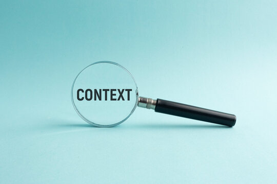 Magnifying glass and letters of the alphabet with context words. the concept of context