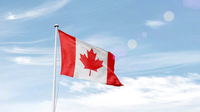 Canada national flag waving in sky.