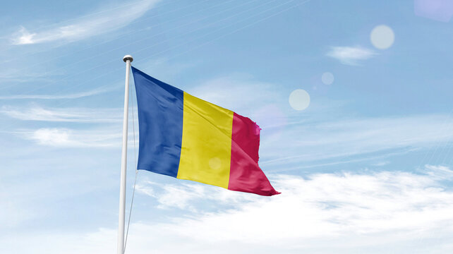 Chad national flag waving in sky.