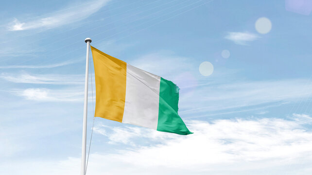 Ivory Coast national flag waving in sky.