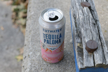 Obraz premium discarded 355 mL RTD cocktail Anheuser-Busch Cutwater Tequila Paloma on a short wall next to cinder block wood cap, Toronto