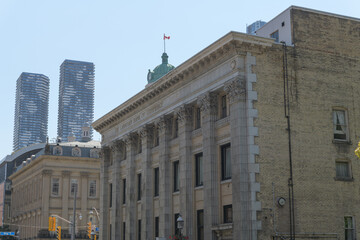 Obraz premium architecture profiles at Jarvis St and King St E, Toronto: Bank of Commerce (Darling & Pearson, 1907) and St Lawrence Hall (William Thomas, 1850)