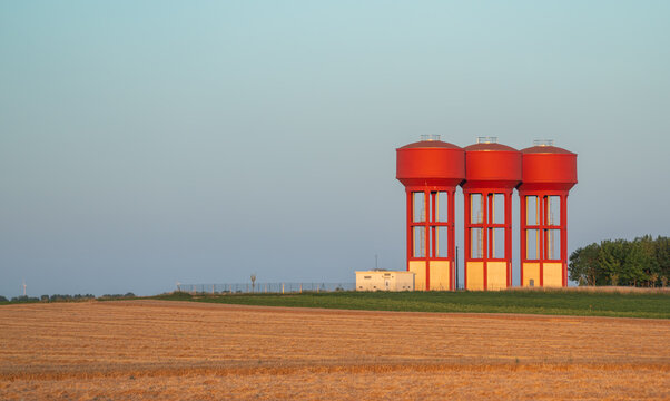 The water tower is located in an agricultural field.