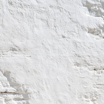 Textured white wall surface, showing rough plaster and irregular shapes