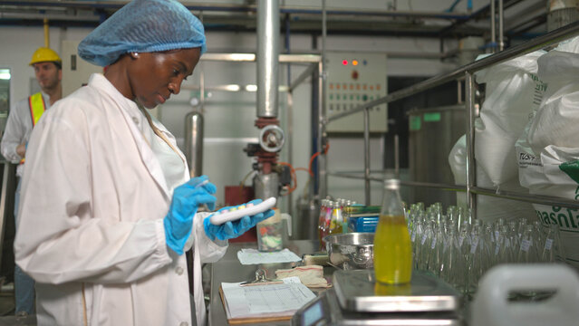 Scientists at a chia seed juice factory are inspecting bottles