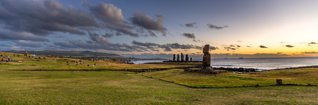 Moais Tahai Archaeological Complex. View of Moai statues at Ahu Tahai on Easter Island at sunset with grassy landscape and ocean in the background, Easter Island, Valparaiso, Chile.