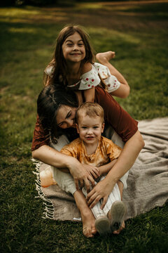 Happy family bonding outdoors enjoying summer park time