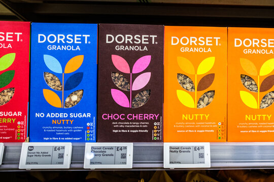 Close-Up Product Shot Of Dorset Cerals Granola Cartons Including Nutty, Choc Cherry, And No Added Sugar Nutty With Price Tags