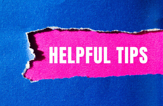 Helpful tips message written on ripped torn paper background. Conceptual Helpful tips symbol. Copy space.