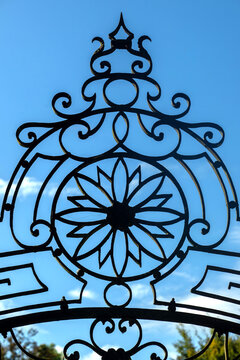 View of the intricate wrought-iron gate detail featuring a floral motif at the Jardim Botanico da Universidade de Coimbra in Coimbra, Coimbra, Portugal.