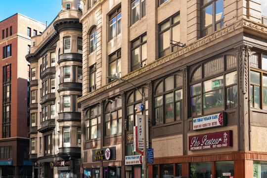 Asian restaurants and storefronts along historic Chinatown in downtown Boston, showcasing traditional architectural facades, restaurant signage, and ornate building details in Massachusetts.
