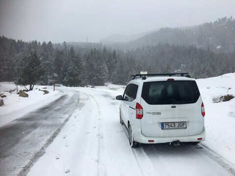 Bolquere, France; January 10 2017: White van driving on snowy road in Bolquere, France