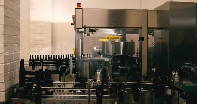 Beer bottles on automated bottling machine in brewery Berlin