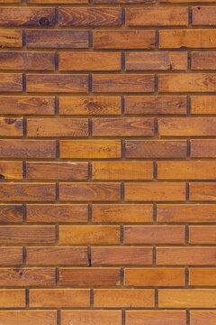 Rustic brown wooden brick wall texture featuring weathered surfaces, natural wood grain, and varied warm earthy tones. The repeating horizontal pattern creates an authentic vintage and industrial aest