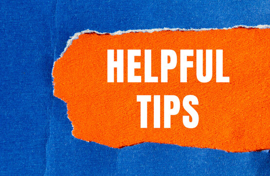 Helpful tips message written on ripped torn paper background. Conceptual Helpful tips symbol. Copy space.