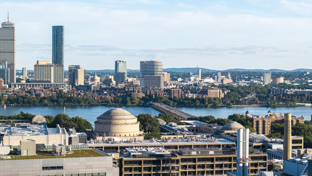 Aerial view of the MIT Great Dome and campus buildings, with the Charles River and Boston skyline in the background in Cambridge, Massachusetts, United States.