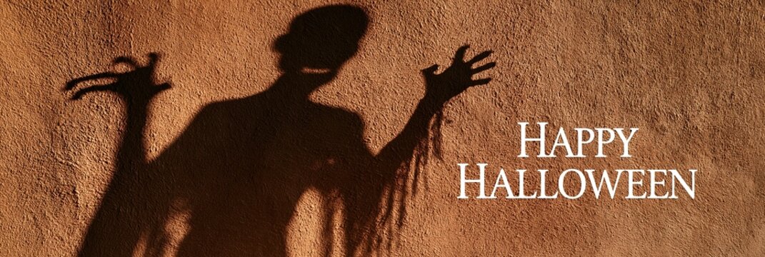 Scary monster shadow on rustic wall with text Happy Halloween, panoramic banner for holiday celebration