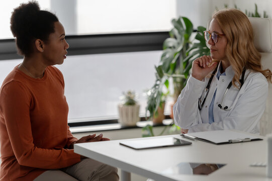 Doctor and patient having an attentive face-to-face conversation, representing patient-centered care and communication in healthcare