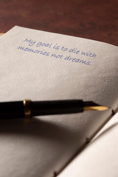 Leather journal page with a my goal quote phrase written with a fountain pen background. Iinspiring mindfulness lifestyle quote concept