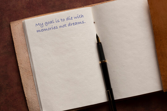 Leather journal page with a my goal quote phrase written with a fountain pen background. Iinspiring mindfulness lifestyle quote concept