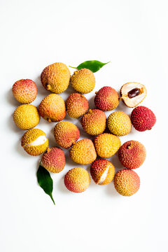 Exotic lychee fruit with green leaves, top view. Healthy vegetarian meal