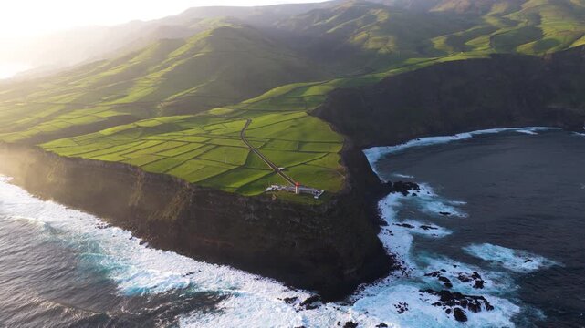 Farol da Ponta do Albarnaz, Stands On A Steep Coastal Cliff On Flores Island In The Azores, Portugal. Aerial Shot