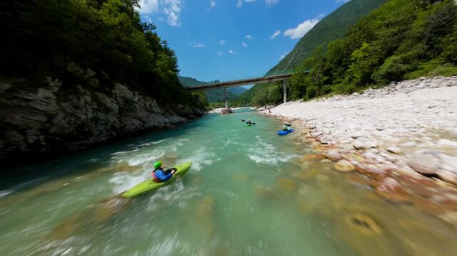 Kayaking On Soca Valley Flowing Under The Bridge In Slovenia. - aerial FPV shot