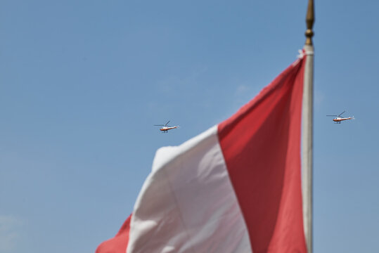 Peruvian flag with military helicopters flying in formation