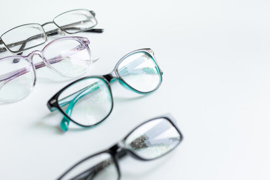 Set of glasses with different frame in optics store. Eyesight and vision concept.