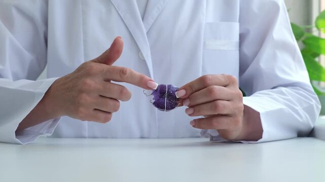 Female doctor orthodontist showing orthodontic plate for children correcting upper jaw. Device for dental treatment. Teeth correction, gnathology concept
