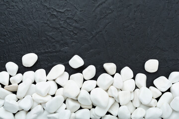 White pebble stones on concrete background, top view © Liami
