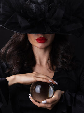 Beautiful young woman wearing witch costume holding a broomstick