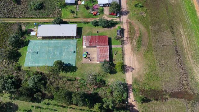 Aerial Top Down View of Rural School with Sports Field in Argentina with Soccer Field and Dirt Roads