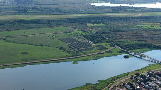 Solar panel installation surrounded by green wetlands and waterways near Posadas in Misiones Province, Argentina.