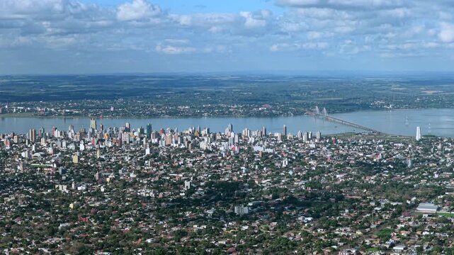 Aerial drone footage shows the Posadas skyline with the international bridge to Encarnacion in the distance.