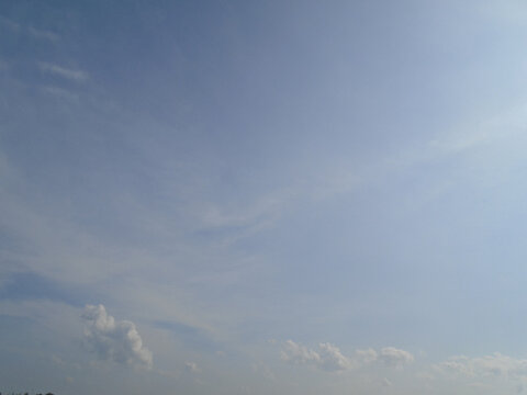 Clear blue sky with light wispy clouds on a bright sunny day