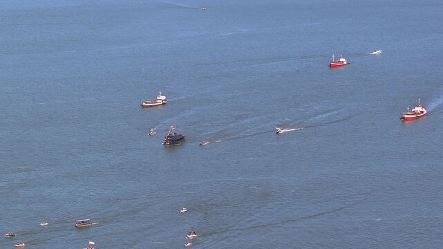Multiple naval and support vessels travel in formation across the Paran&aacute; River during a coordinated maritime operation.