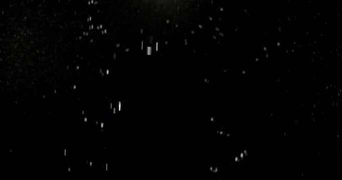 Slow motion floating water droplets on a black background. Premium VFX overlay for cinematic compositing, motion graphics, title animations, trailers and professional visual effects.