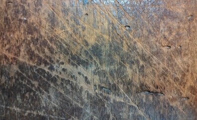 Fototapeta premium Old weathered wood texture background with deep scratches and rustic character. Dark, aged timber surface showcasing natural grain lines, distress marks, and a vintage aesthetic perfect for background