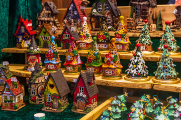 Naklejka premium Traditional ceramic Christmas tree candle holders and fairy houses for sale at the Christmas market in Regensburg, Germany