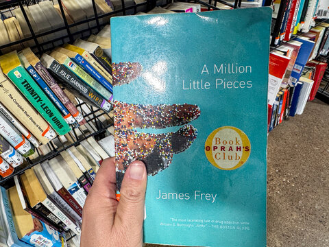 Mesa, Arizona - August 29, 2026: Hand holds A Million Little Pieces book, a popular Oprahs Book Club edition from the early 2000s