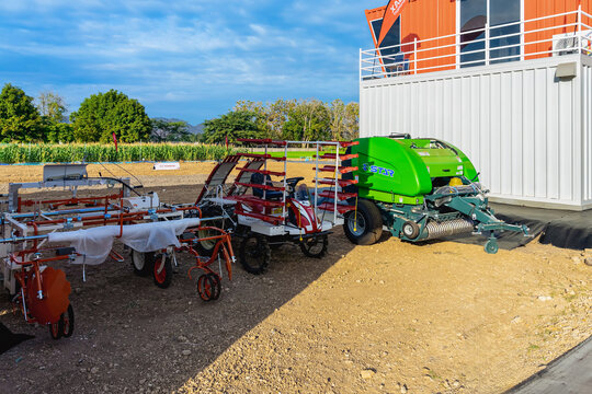 KANCHANABURI, THAILAND-AUGUST 16, 2026: View of various modern agricultural equipment, round baler with rice transplanters and farm tractors showcased at Chia Tai Company Limited exhibition pavilion.