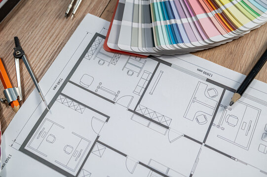 Architectural Blueprint with Colorful Swatch Palette Fan and Drawing Tools for Interior Design