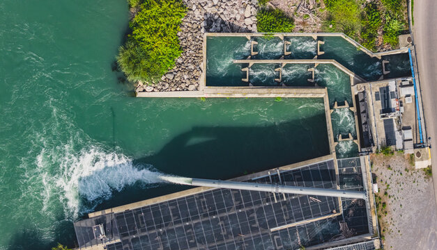 Aerial view of the Le Pouzin hydroelectric power plant and fish passage featuring renewable energy infrastructure and water flow in Le Pouzin, Auvergne-Rhone-Alpes, France.