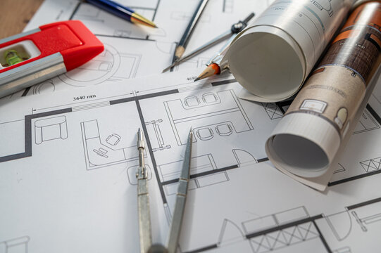 Architectural Blueprint Rolls and House Floor Plan Papers for Home Project Design Concept