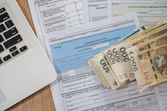 Close up of Polish PIT Declaration Documents with Pen and Zloty Cash Stack for Tax Refund Day