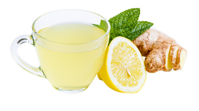 Glass cup of hot lemon ginger tea with fresh mint leaves and lemon slice