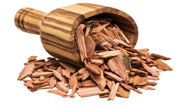 Red cedar wood chips spilling from a small rustic wooden scoop